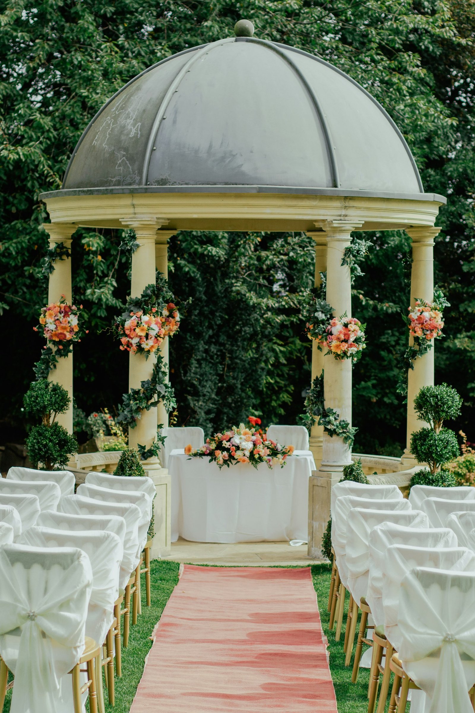 Floral gazebo ceremony aisle at a garden manor, The Cotswolds